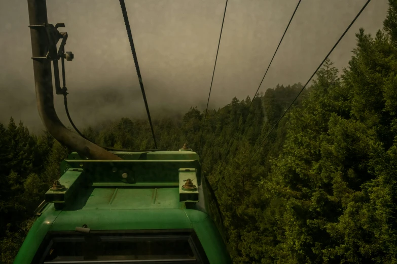 an aerial view of trees and sky with the gondola in front of it