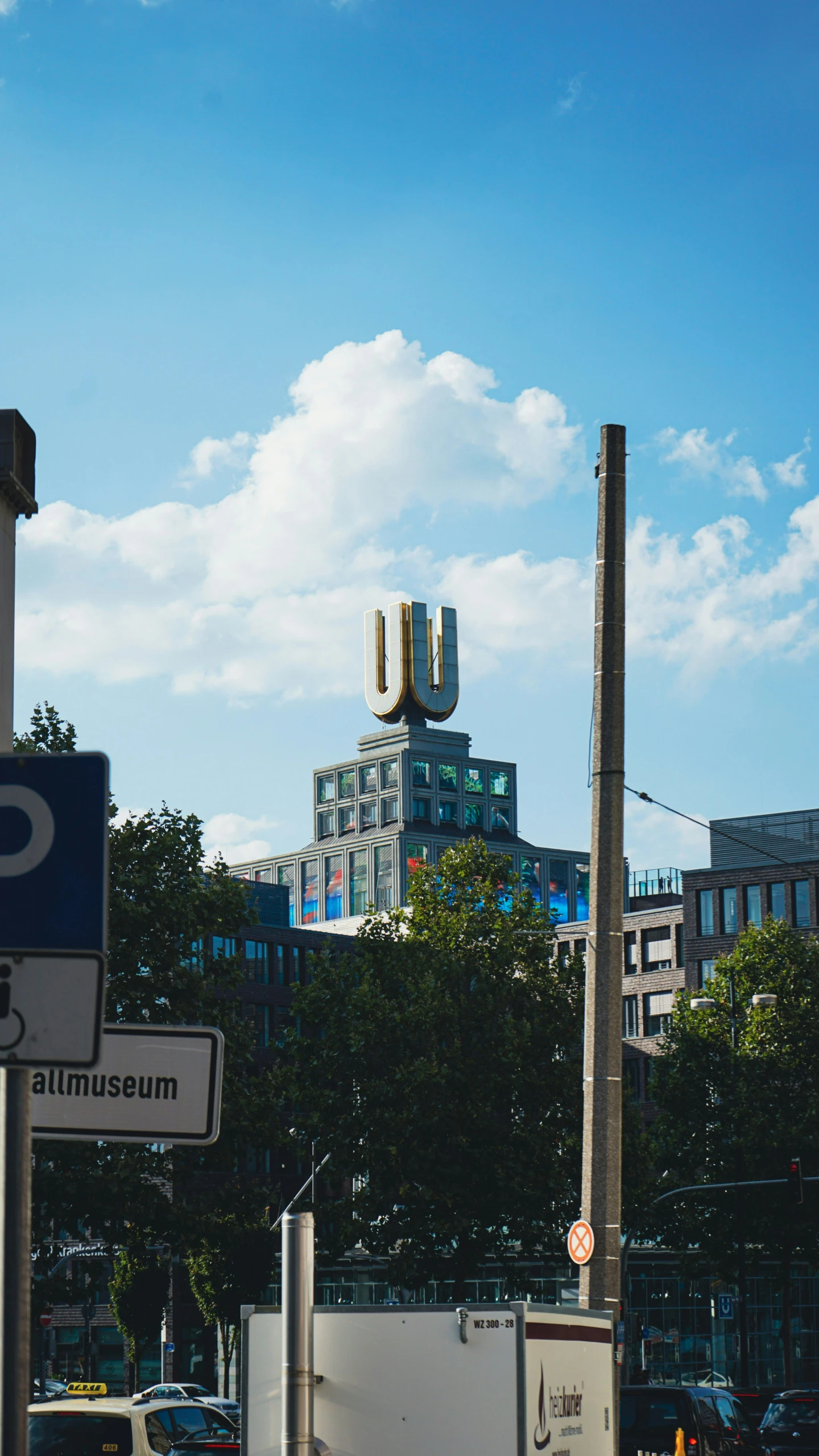 a picture of a street with traffic signs and tall buildings in the background