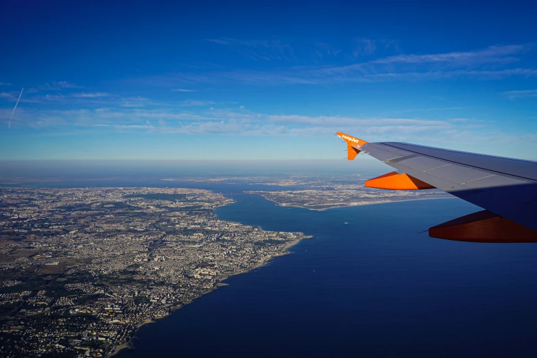 the wing of an airplane as seen through an airplane window