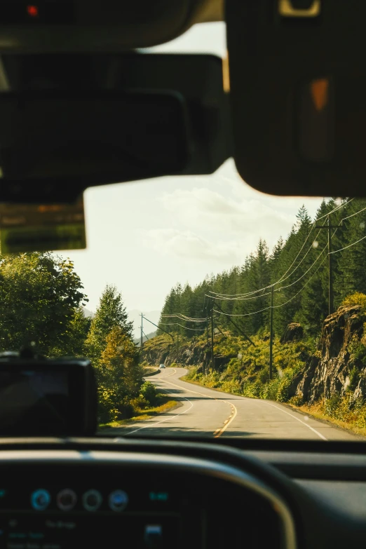 the view from inside of a car in the road