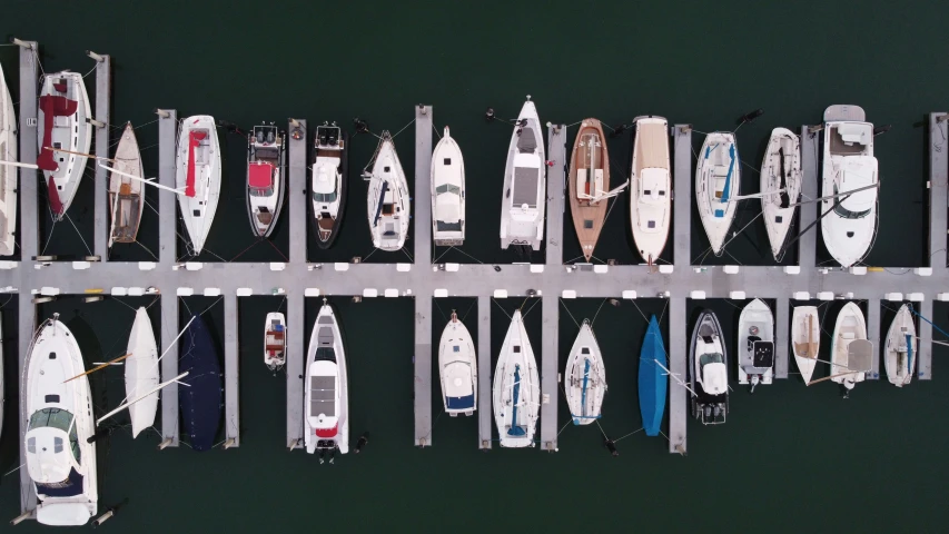 many boats lined up next to each other in a pier