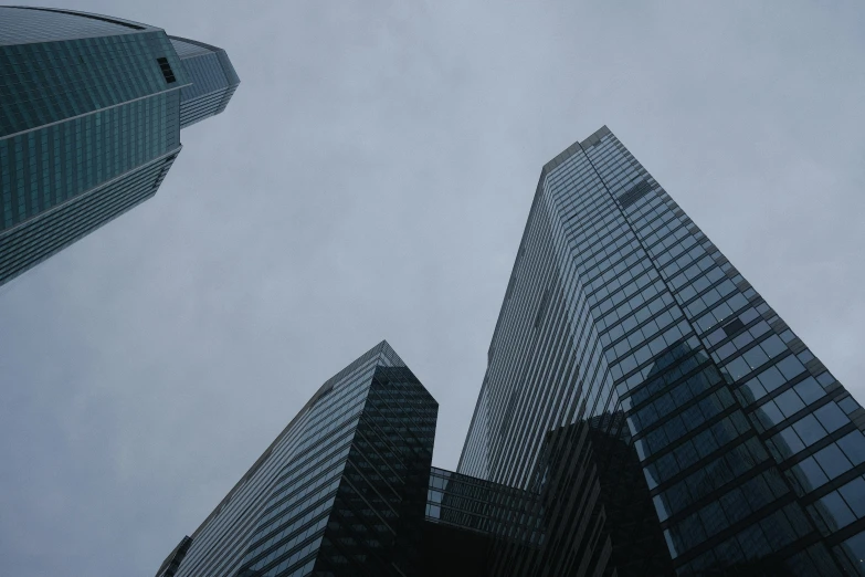 two tall buildings in the air, each with a blue sky