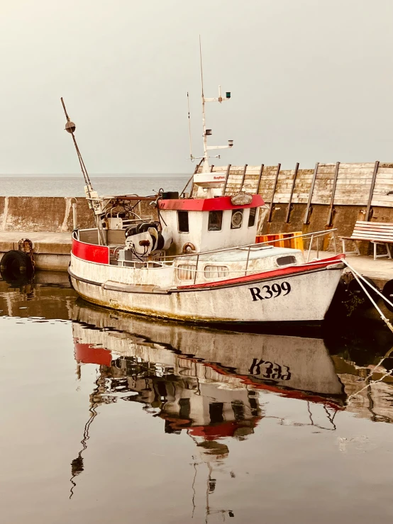 a small boat is docked next to the harbor