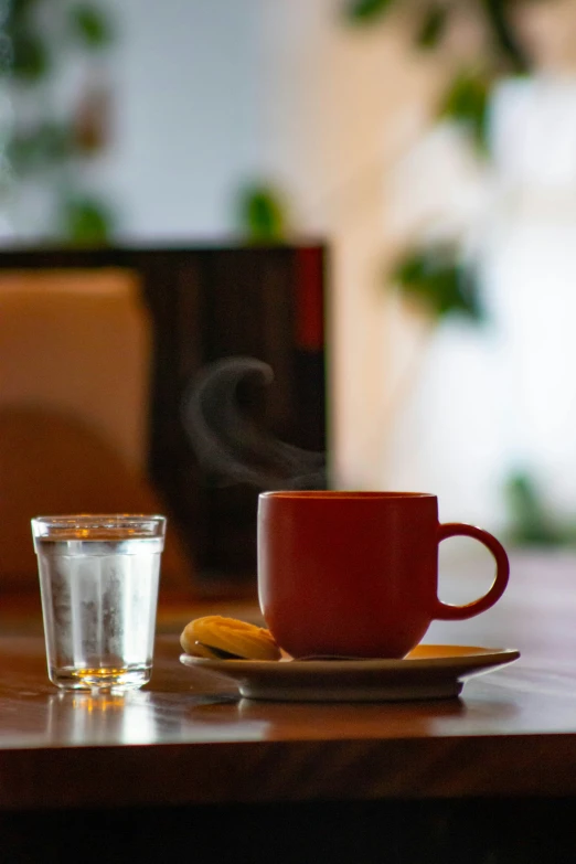 a cup of coffee and half a banana on a wooden table