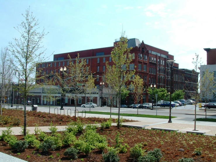 a street view of a brick building and cars