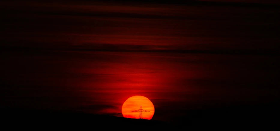 a clock tower that is near the sun