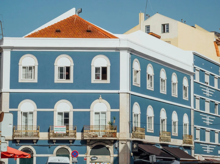 a blue and white building sitting on the side of a street