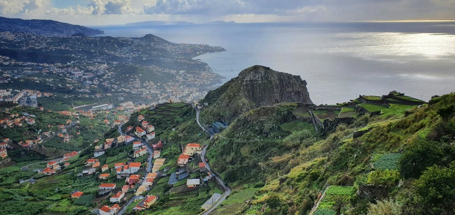 a scenic view of a small town on top of a mountain