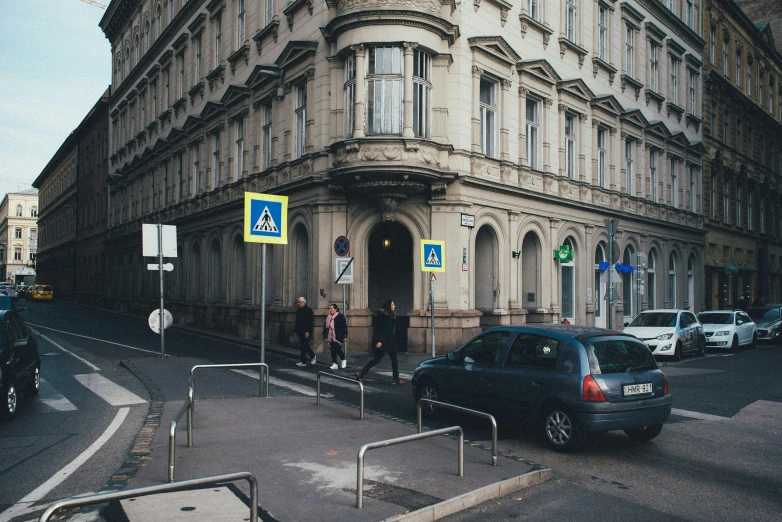 cars are parked in front of an old building