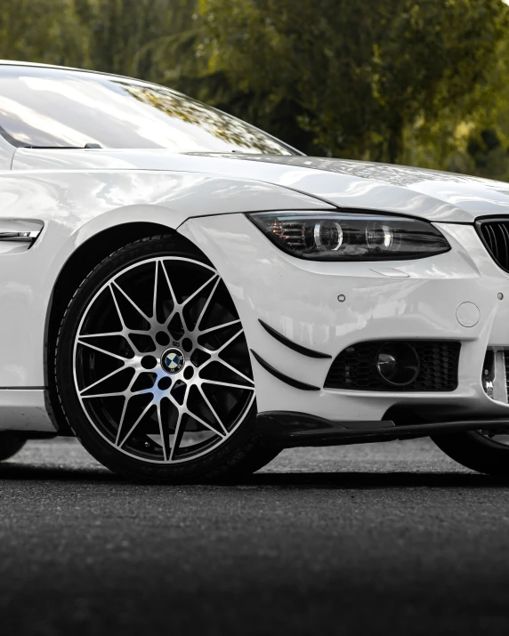 a white sports car parked on the side of the street