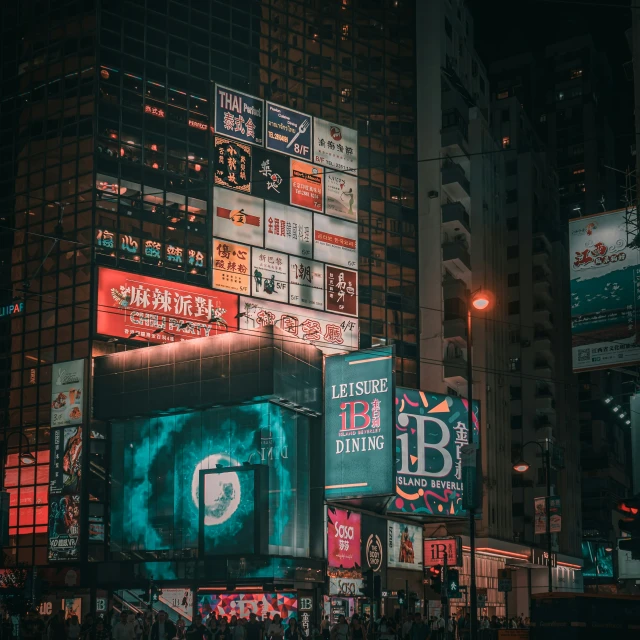 large lit up billboards on buildings on the street