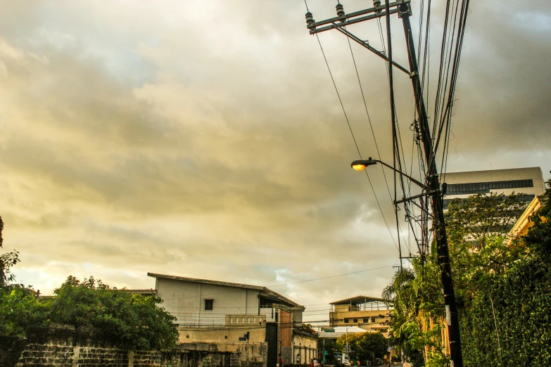 telephone poles and street light with building in the background