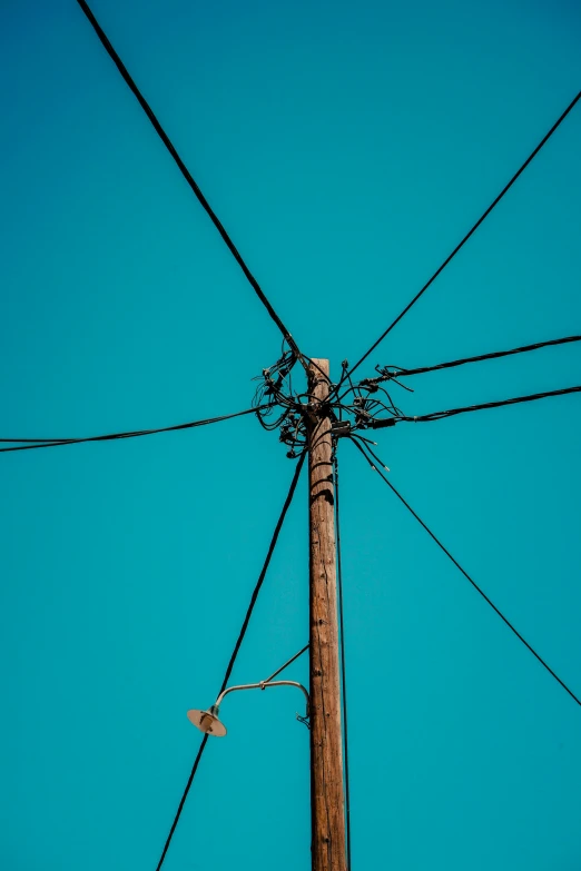 a telephone pole that has a bunch of wires on top of it