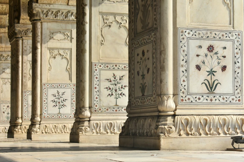 a stone building has a fancy pattern and a bench