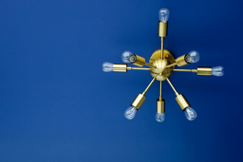 an elegant chandelier with nine lights is suspended on the wall