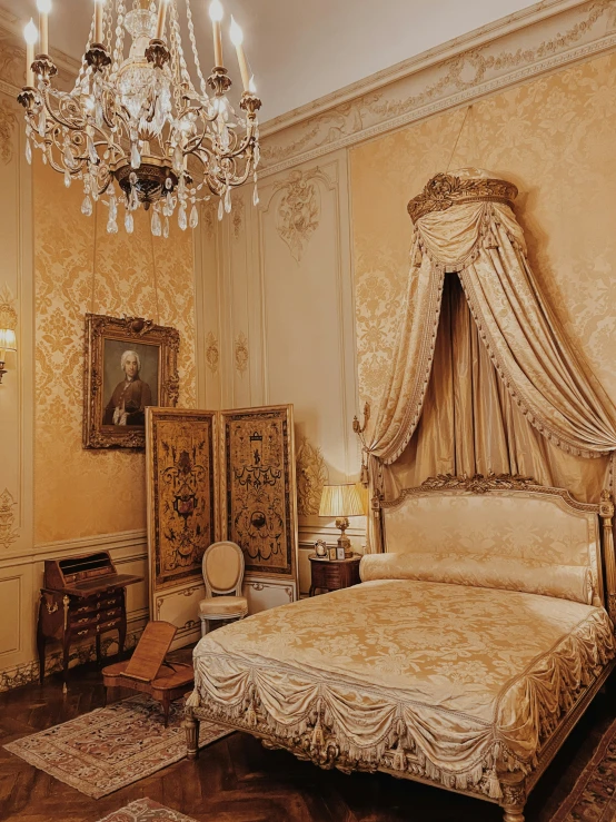 a fancy bedroom with a gold color and beige colors