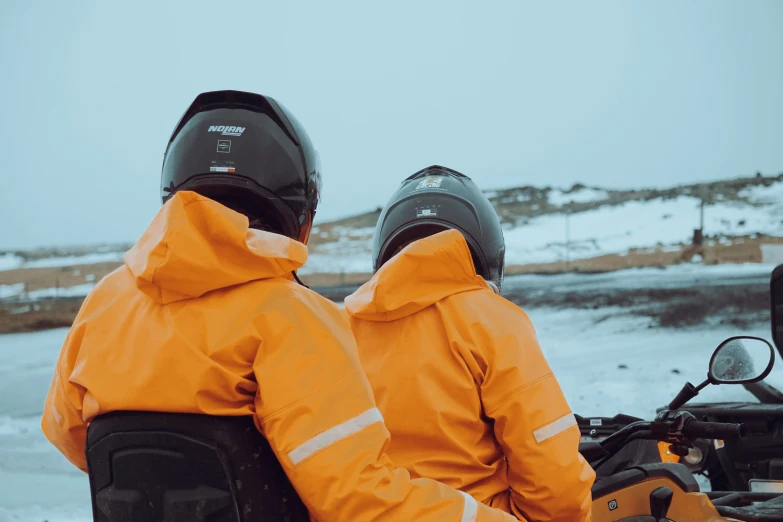 two people in ski gear on a motor bike