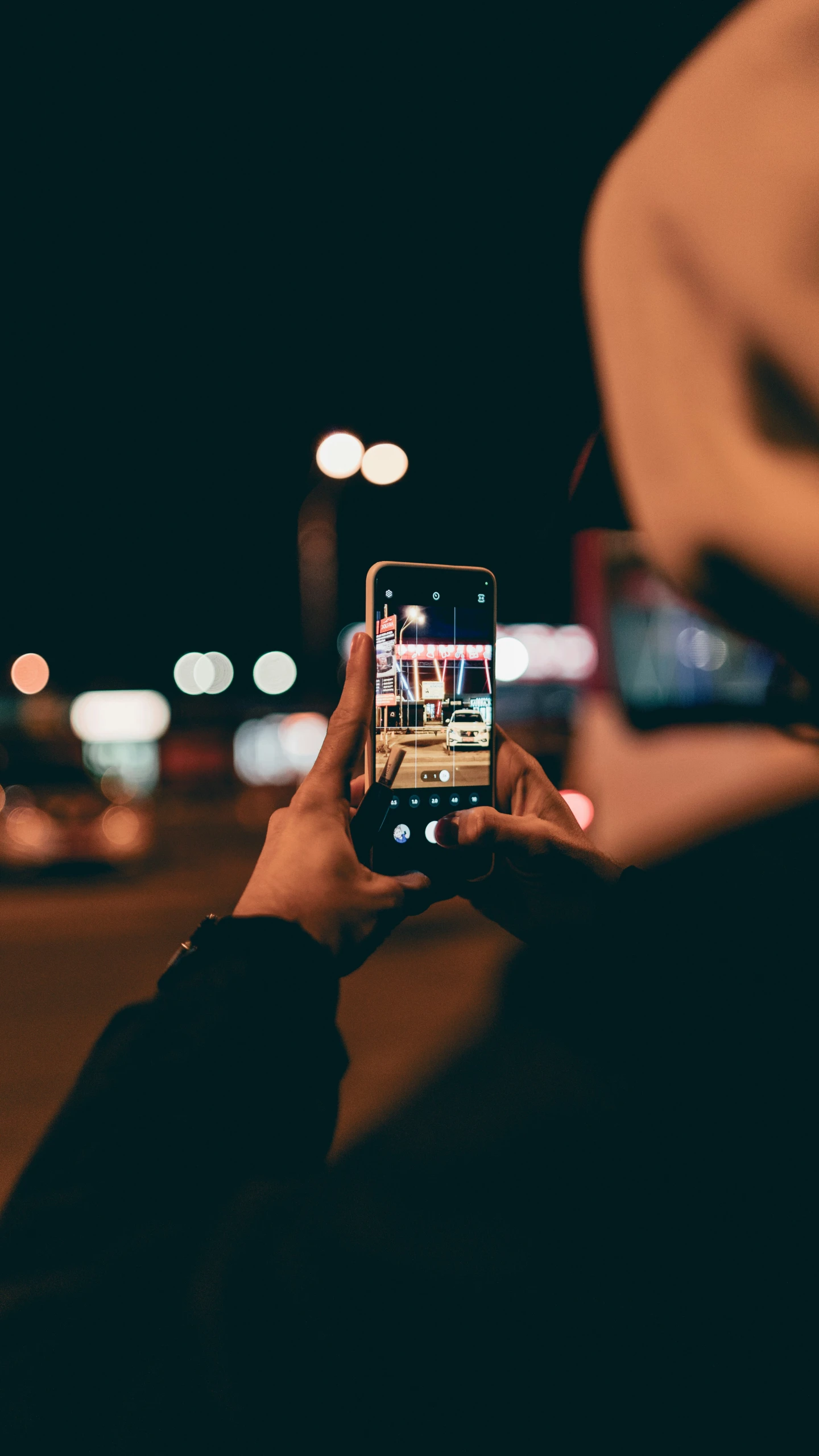 person holding up a smartphone to take a po