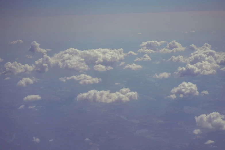 some clouds are seen in the sky from above