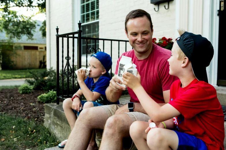 a father and son sharing a box of ice cream