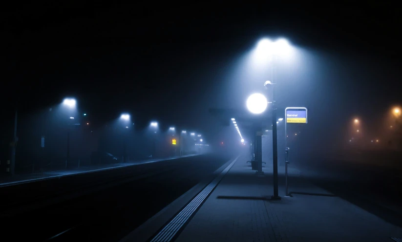 a street light on the side of a train track