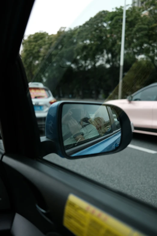a car mirror showing it's side view in the back of it