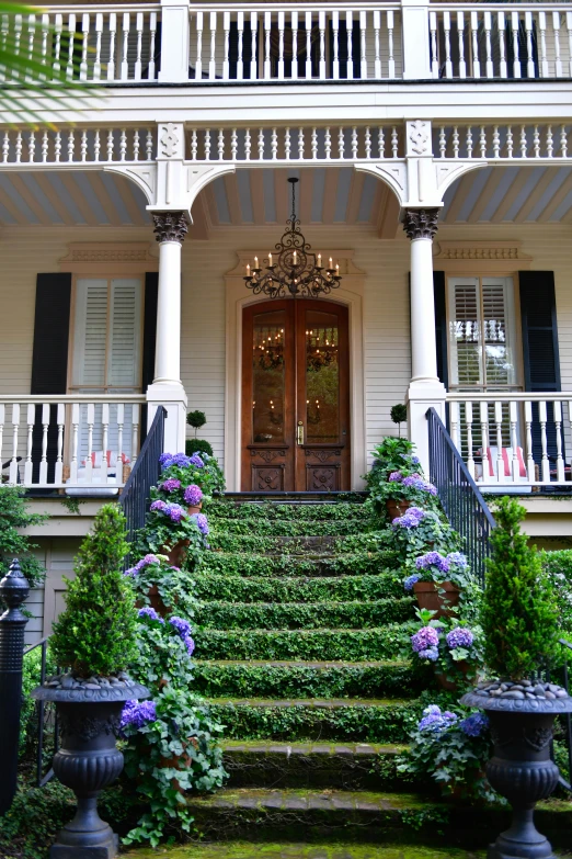 the entrance to a house with a wrought iron fence