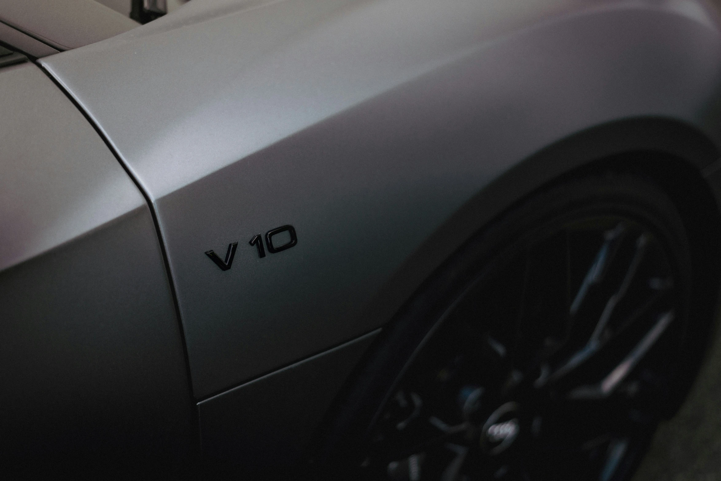 a grey sports car with a v10 decal