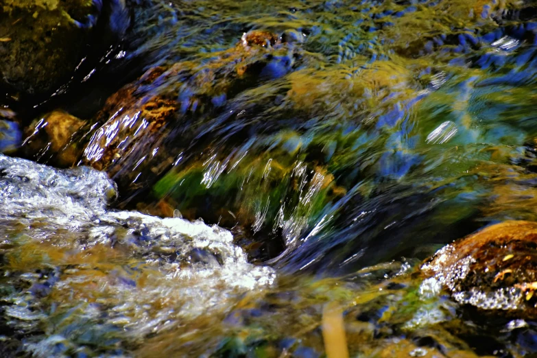 water running over some rocks in a river