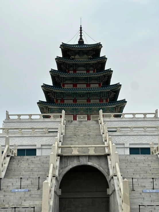 a large chinese building with a tower above it