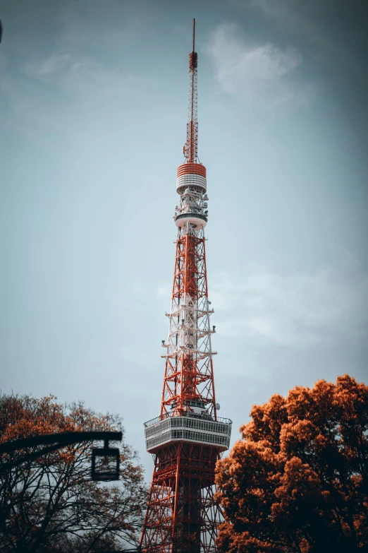 the tv tower is made from metal with lots of people standing in it