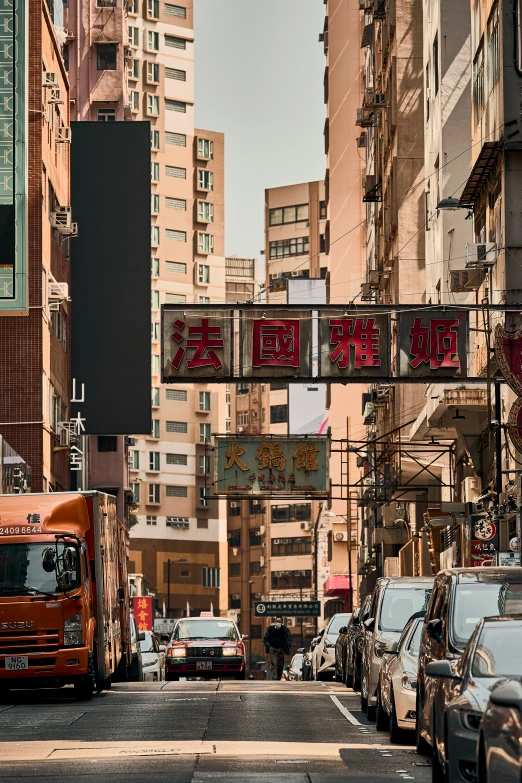 a bus driving down a road with signs and buildings