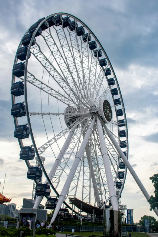 a big ferris wheel that has some people underneath it