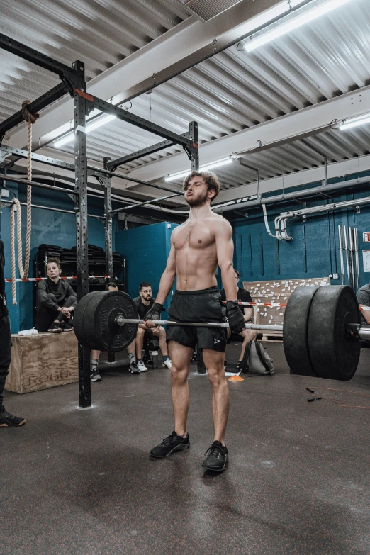 a man working out on the barbell at a gym