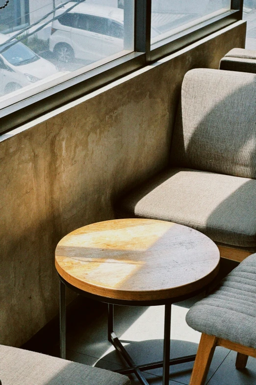 the top of a wooden table next to some chairs