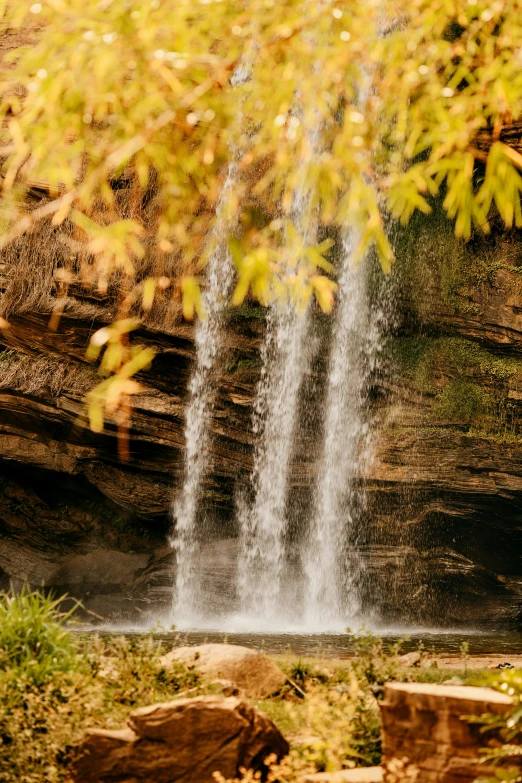 a person riding a horse near a waterfall