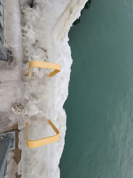 a beach with steps on the water and snow