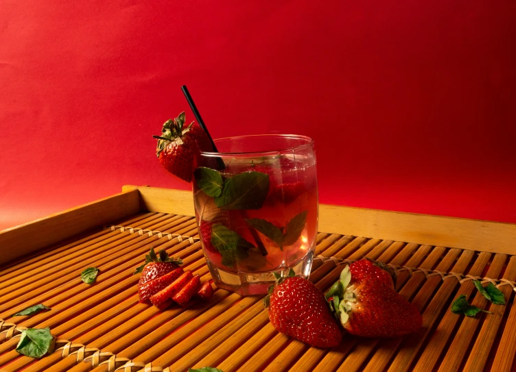 a red tray topped with strawberries and a beverage