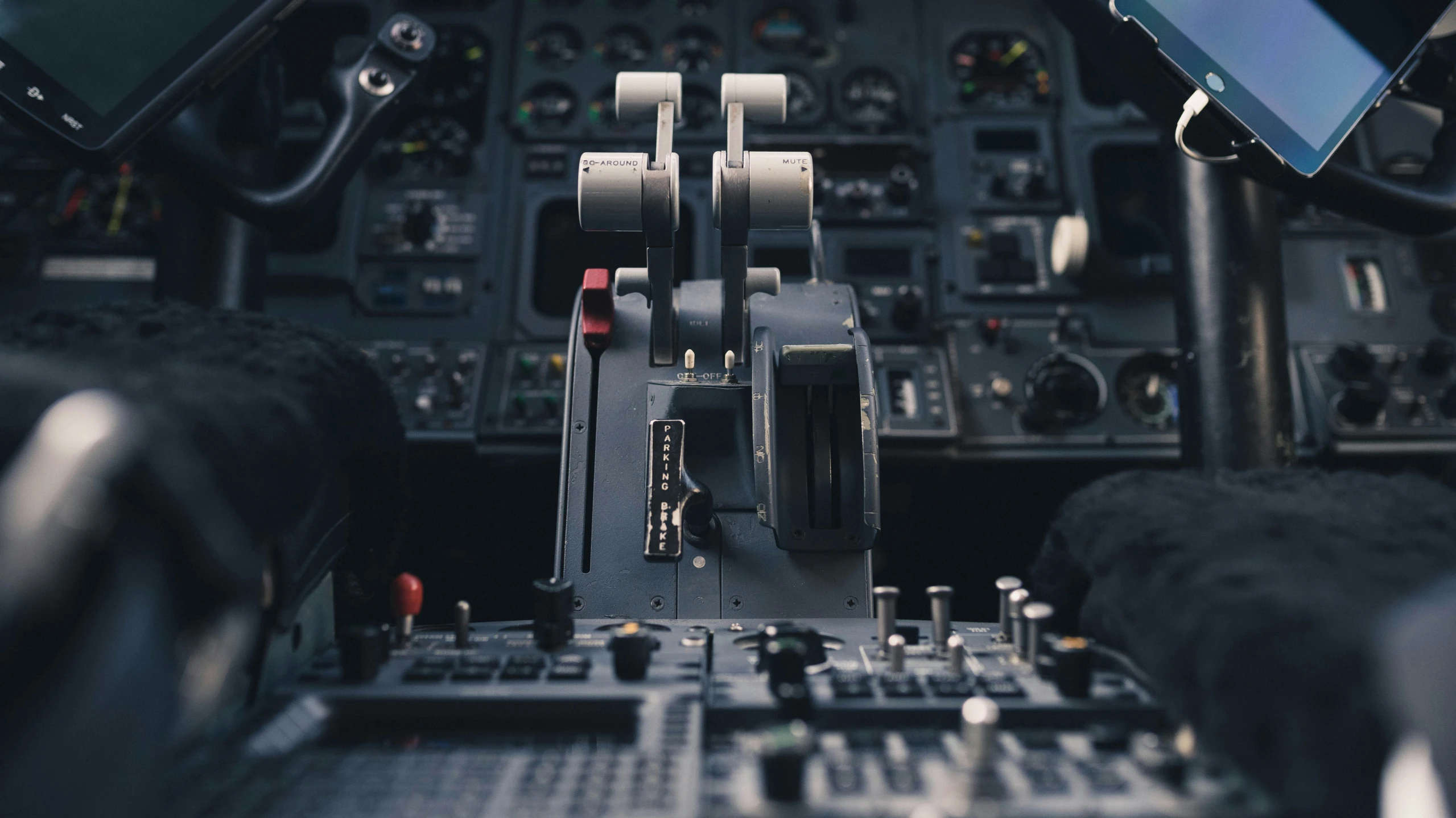 a cockpit of a plane with two phones and dashboard