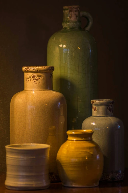 vases and other ceramics sitting on a counter