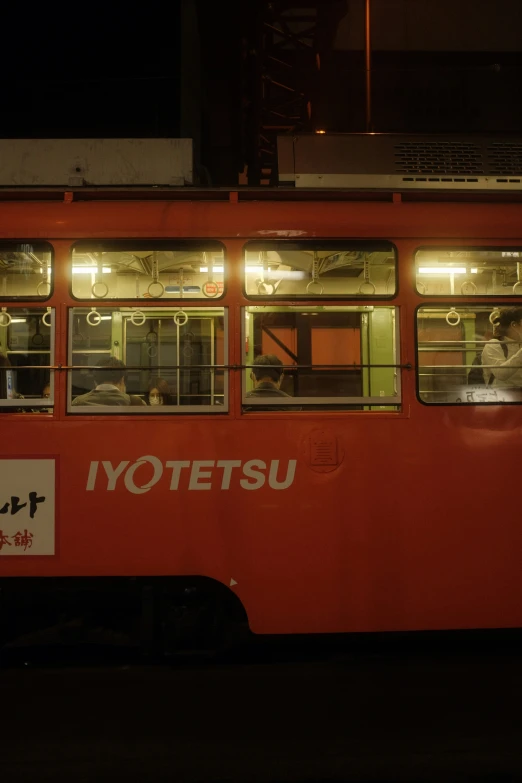 the inside of a red passenger bus on a city street