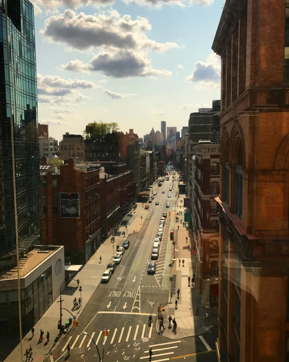 cars parked along a city street lined with tall buildings