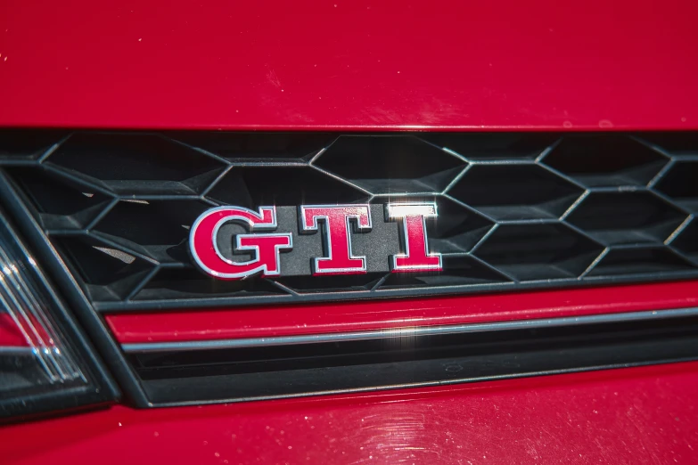 the emblem on the grill of the red car