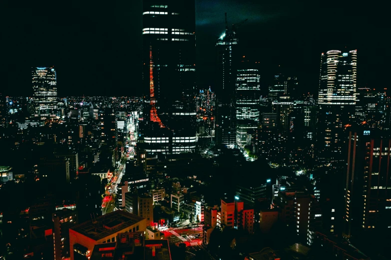 the city lights glow brightly at night with skyscrs in the distance