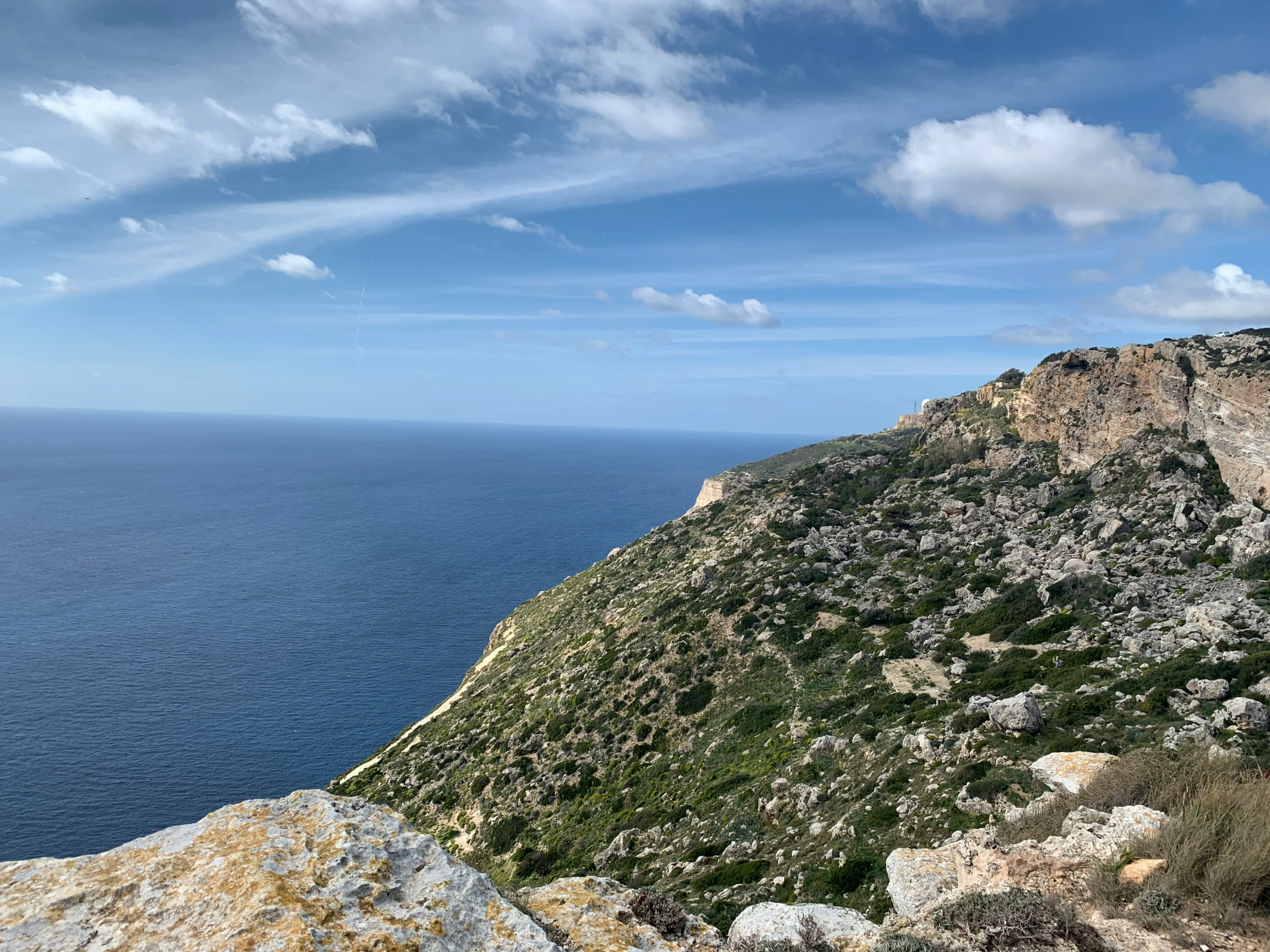 there is a rocky area with some water in the distance