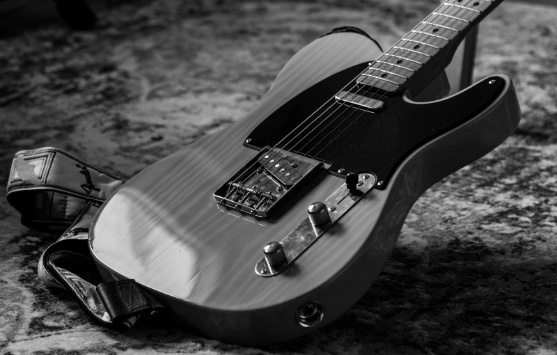 a black and white pograph of an electric guitar