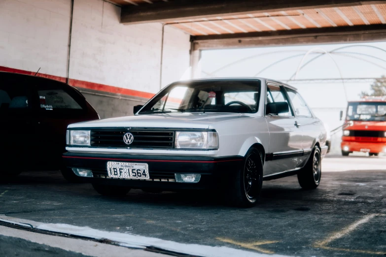 a car is parked inside a garage next to a truck