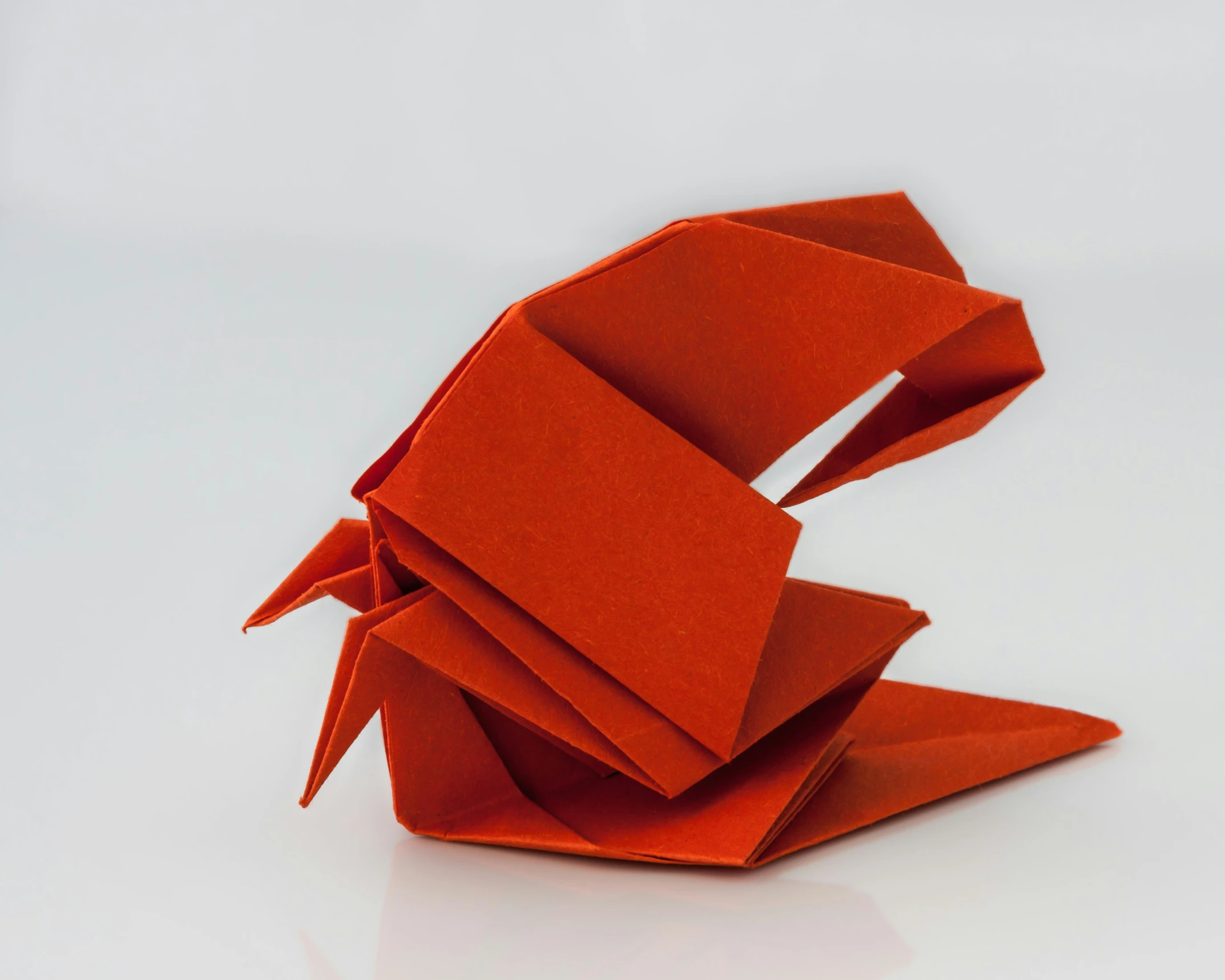 an origami bird made from orange paper