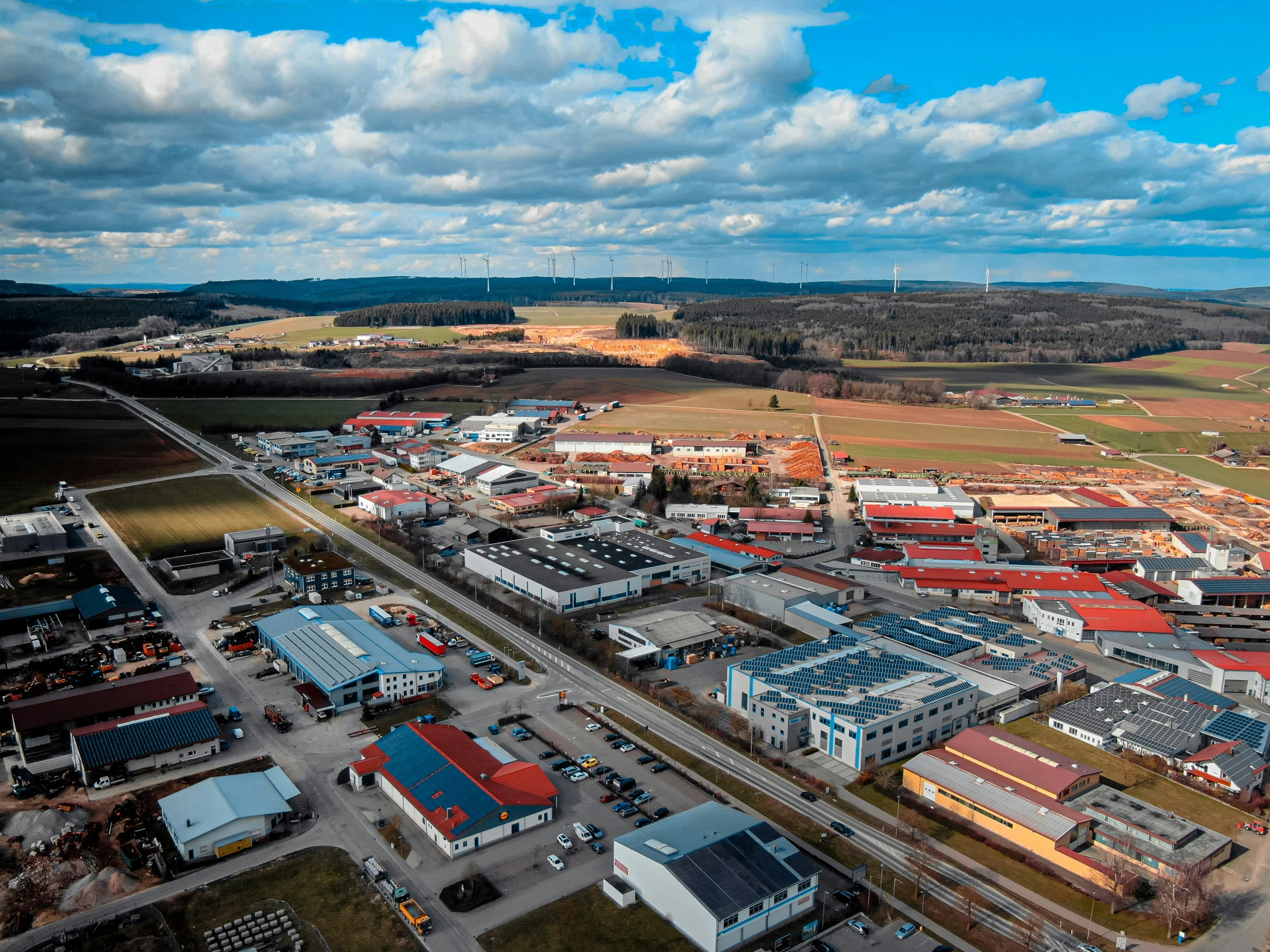 an aerial view of a city with red roofs