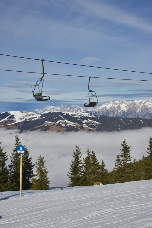 a man riding a ski lift in the snow